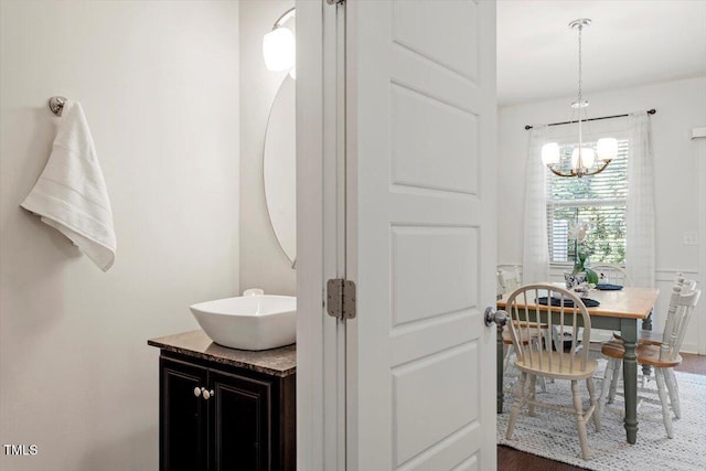 7879 Allscott Way, Raleigh, NC 27612 - bathroom with wood finished floors, a chandelier, and vanity