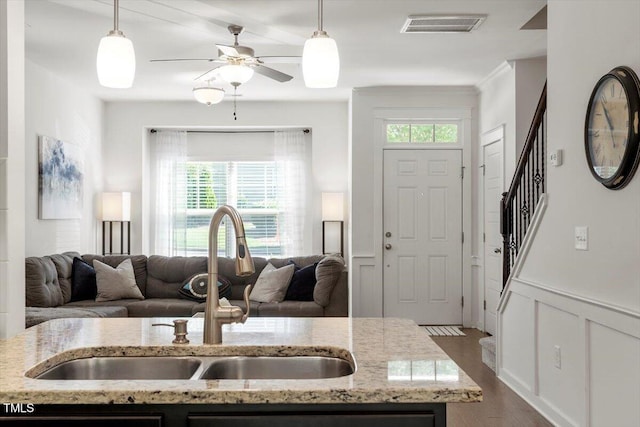 7879 Allscott Way, Raleigh, NC 27612 - kitchen featuring open floor plan, dark wood-type flooring, hanging light fixtures, and a wainscoted wall