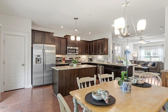 7879 Allscott Way, Raleigh, NC 27612 - dining room featuring a ceiling fan, wood finished floors, and a chandelier