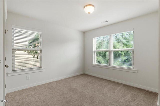 7879 Allscott Way, Raleigh, NC 27612 - empty room featuring healthy amount of natural light and light carpet
