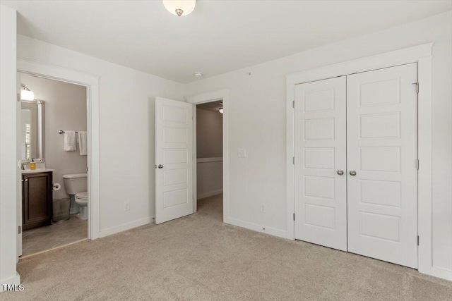 7879 Allscott Way, Raleigh, NC 27612 - unfurnished bedroom featuring light carpet, a closet, and ensuite bathroom