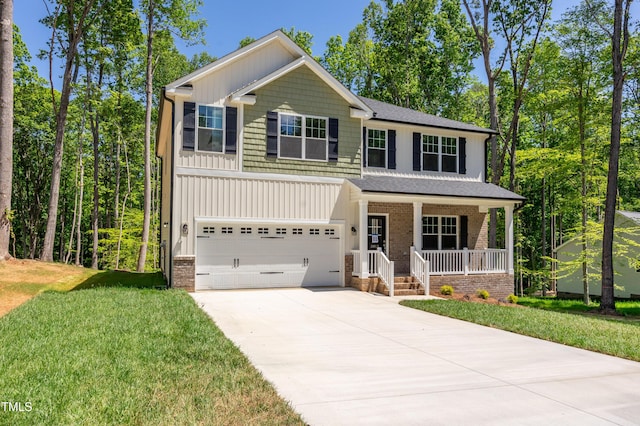 3013 Wesley Farm Ln, Sophia, NC 27350 - view of front of home featuring covered porch, driveway, an attached garage, and a front yard