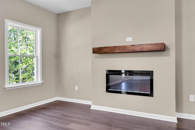 3013 Wesley Farm Ln, Sophia, NC 27350 - unfurnished living room with wood finished floors and a glass covered fireplace
