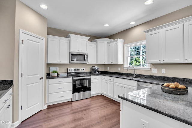 3013 Wesley Farm Ln, Sophia, NC 27350 - kitchen with stainless steel appliances, white cabinets, recessed lighting, and dark stone countertops