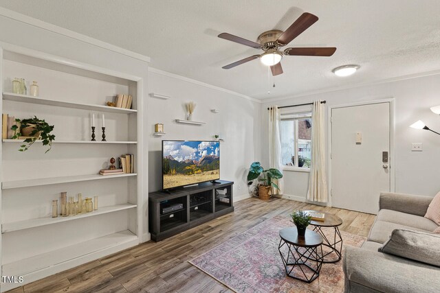 7002 Longstreet Dr Unit C, Raleigh, NC 27615 - living room featuring wood finished floors, crown molding, a ceiling fan, and built in features
