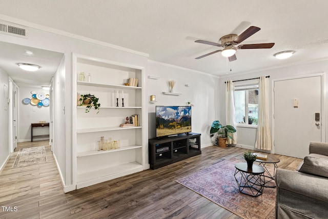7002 Longstreet Dr Unit C, Raleigh, NC 27615 - living area featuring ceiling fan, wood finished floors, crown molding, built in features, and a textured ceiling