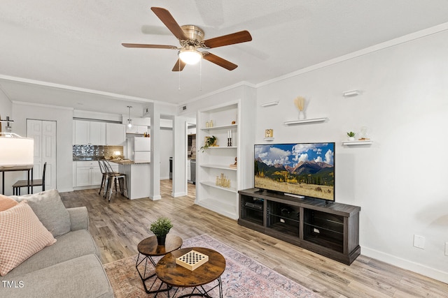 7002 Longstreet Dr Unit C, Raleigh, NC 27615 - living area with a ceiling fan, light wood finished floors, built in features, and crown molding