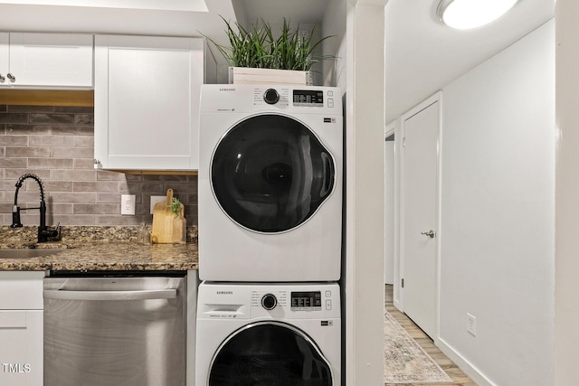 7002 Longstreet Dr Unit C, Raleigh, NC 27615 - laundry area featuring stacked washer / dryer and light wood-style floors