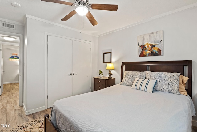 7002 Longstreet Dr Unit C, Raleigh, NC 27615 - bedroom with wood finished floors, a closet, ornamental molding, and a ceiling fan