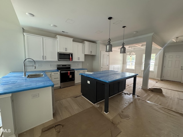 5428 Jaeger Dr Lot # 45, Graham, NC 27253 - kitchen with appliances with stainless steel finishes, white cabinetry, ornamental molding, hanging light fixtures, and tasteful backsplash