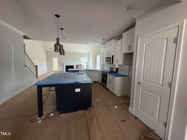 5428 Jaeger Dr Lot # 45, Graham, NC 27253 - kitchen featuring stainless steel appliances, white cabinets, a kitchen island, a fireplace, and backsplash