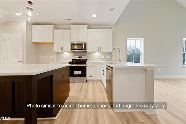5428 Jaeger Dr Lot # 45, Graham, NC 27253 - kitchen with appliances with stainless steel finishes, light wood-style floors, white cabinetry, decorative backsplash, and recessed lighting