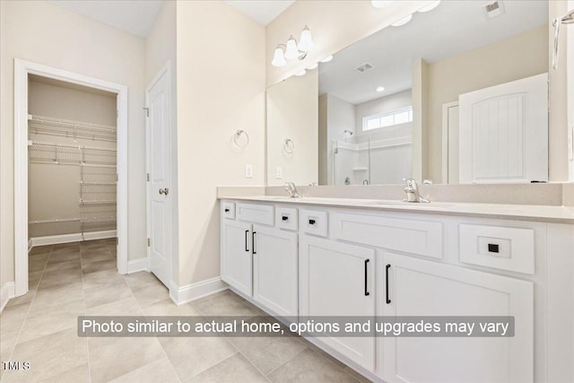 5428 Jaeger Dr Lot # 45, Graham, NC 27253 - full bath with double vanity, a walk in closet, and tile patterned flooring