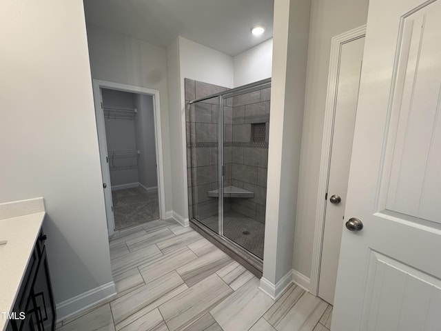 5428 Jaeger Dr Lot # 45, Graham, NC 27253 - bathroom with a shower stall, vanity, and a walk in closet
