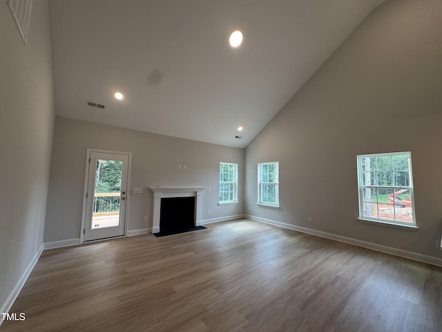 5428 Jaeger Dr Lot # 45, Graham, NC 27253 - unfurnished living room with high vaulted ceiling, wood finished floors, recessed lighting, and a fireplace
