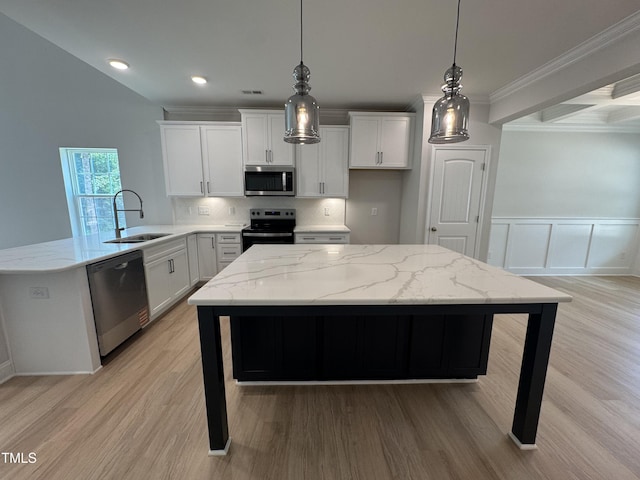 5428 Jaeger Dr Lot # 45, Graham, NC 27253 - kitchen featuring appliances with stainless steel finishes, a peninsula, light stone countertops, light wood-style flooring, and crown molding