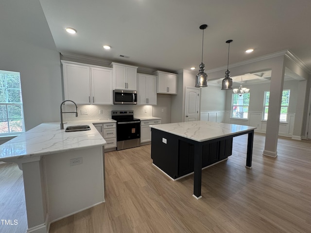 5428 Jaeger Dr Lot # 45, Graham, NC 27253 - kitchen featuring stainless steel appliances, light stone counters, a chandelier, backsplash, and white cabinets