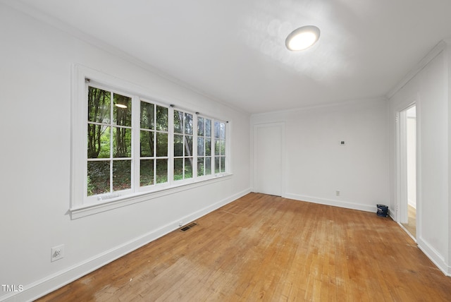 1219 Carlton Ave, Raleigh, NC 27606 - empty room with light wood-type flooring and crown molding