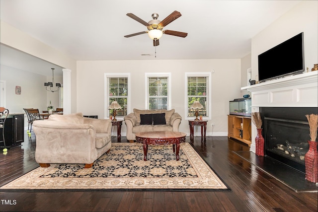 1726 Rapids Ct, Franklinton, NC 27525 - living room featuring a ceiling fan, a fireplace, dark wood-style floors, and a chandelier