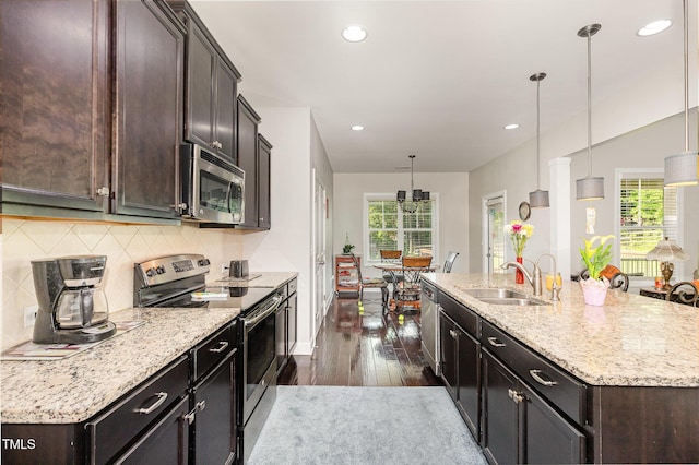 1726 Rapids Ct, Franklinton, NC 27525 - kitchen featuring appliances with stainless steel finishes, plenty of natural light, dark wood-style floors, decorative backsplash, and recessed lighting