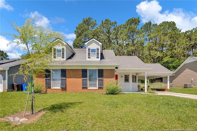 2240 Spindle Tree Dr, Fayetteville, NC 28304 - new england style home with a front yard, brick siding, an attached carport, driveway, and a shingled roof