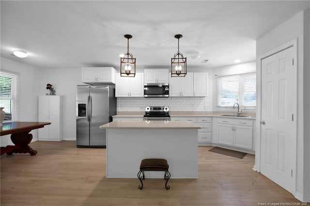 2240 Spindle Tree Dr, Fayetteville, NC 28304 - kitchen with stainless steel appliances, plenty of natural light, and white cabinets
