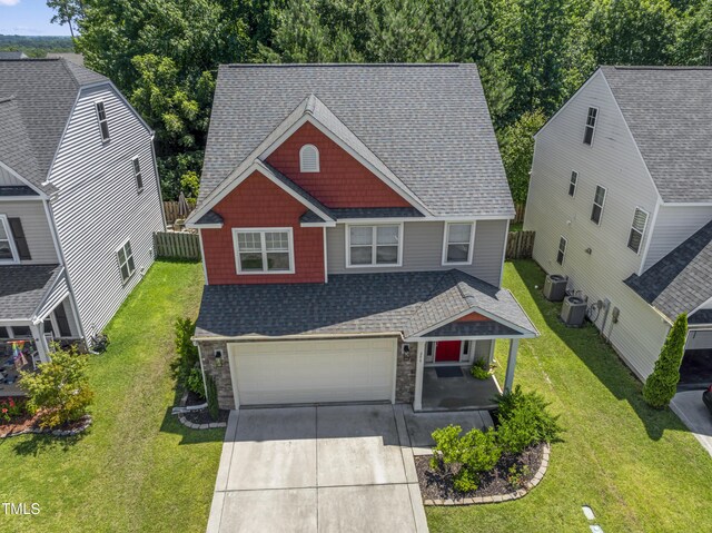 274 Marsh Creek Dr, Garner, NC 27529 - craftsman house featuring a garage, concrete driveway, a shingled roof, covered porch, and stone siding