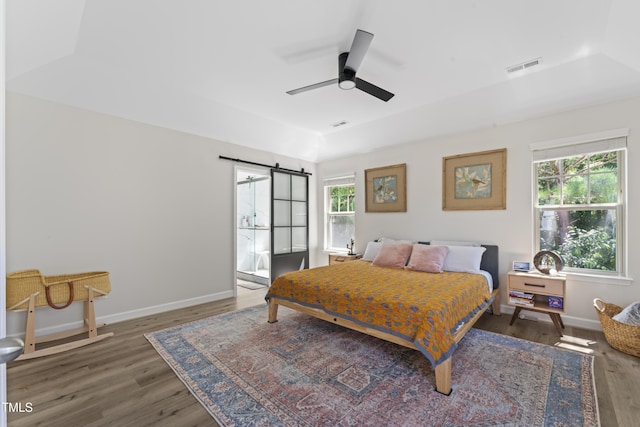 274 Marsh Creek Dr, Garner, NC 27529 - bedroom with multiple windows, wood finished floors, a barn door, and ceiling fan