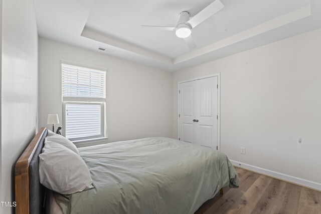 274 Marsh Creek Dr, Garner, NC 27529 - bedroom featuring a tray ceiling, wood finished floors, and a ceiling fan