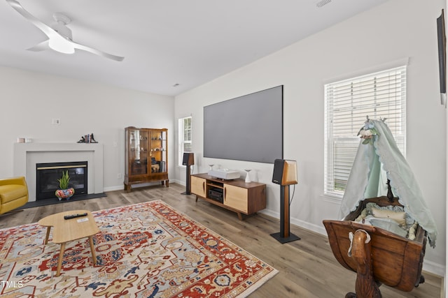 274 Marsh Creek Dr, Garner, NC 27529 - living area with wood finished floors, plenty of natural light, and a fireplace with flush hearth
