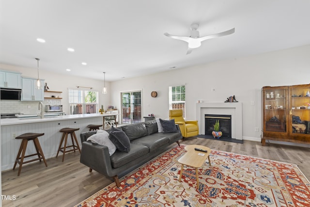 274 Marsh Creek Dr, Garner, NC 27529 - living area featuring light wood finished floors, a ceiling fan, recessed lighting, and a fireplace with flush hearth