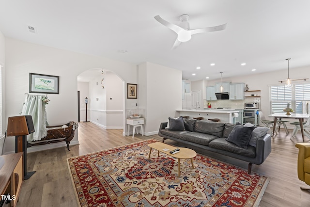 274 Marsh Creek Dr, Garner, NC 27529 - living room with a ceiling fan, arched walkways, light wood-style flooring, and recessed lighting