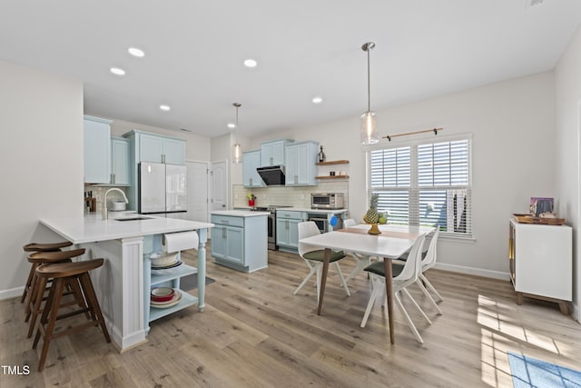 274 Marsh Creek Dr, Garner, NC 27529 - kitchen featuring open shelves, refrigerator, stainless steel range with electric stovetop, decorative backsplash, and blue cabinets