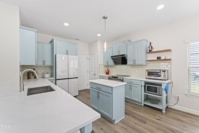 274 Marsh Creek Dr, Garner, NC 27529 - kitchen featuring stainless steel appliances, blue cabinetry, exhaust hood, tasteful backsplash, and recessed lighting