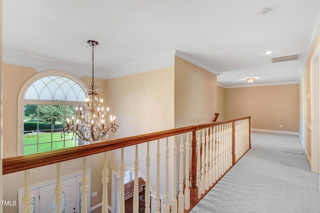 106 Woodmere Ln, Goldsboro, NC 27530 - hallway with healthy amount of natural light, an upstairs landing, carpet, ornamental molding, and a chandelier