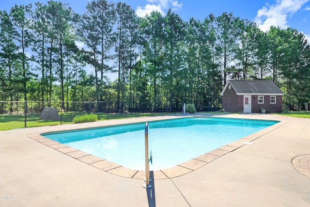 106 Woodmere Ln, Goldsboro, NC 27530 - swimming pool featuring an outdoor structure, a patio area, a storage structure, and view of scattered trees