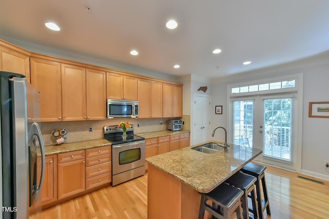 119 Jones Creek Pl Unit 119, Chapel Hill, NC 27516 - kitchen with appliances with stainless steel finishes, light wood finished floors, decorative backsplash, light stone counters, and recessed lighting