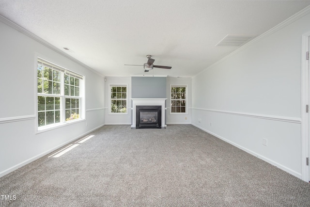 709 Woodgreen Dr, Durham, NC 27704 - unfurnished living room featuring ornamental molding, carpet floors, a ceiling fan, a fireplace with flush hearth, and a textured ceiling