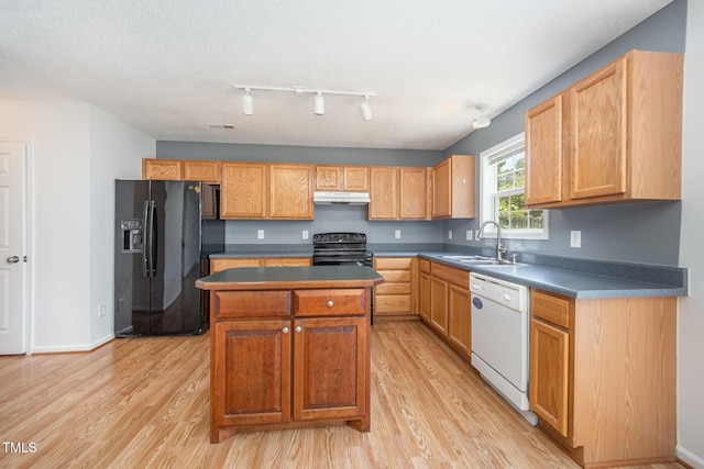 709 Woodgreen Dr, Durham, NC 27704 - kitchen with black appliances, light wood-style flooring, a kitchen island, and track lighting