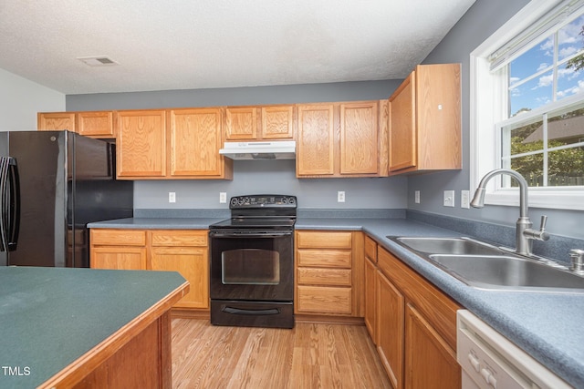 709 Woodgreen Dr, Durham, NC 27704 - kitchen featuring black appliances, under cabinet range hood, and light wood finished floors
