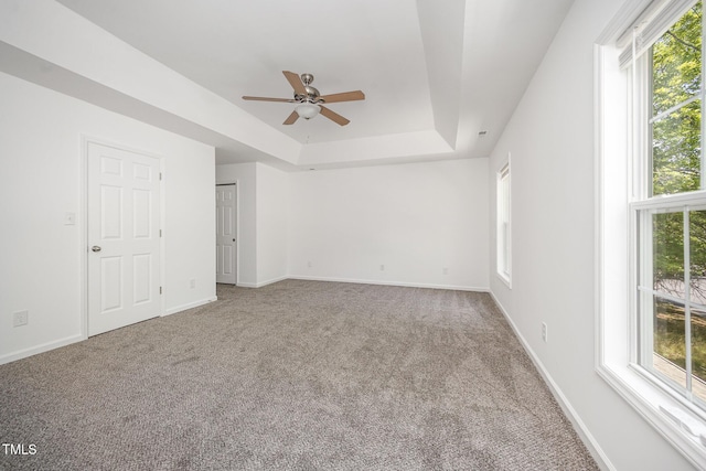 709 Woodgreen Dr, Durham, NC 27704 - unfurnished room with a ceiling fan, carpet floors, plenty of natural light, and a tray ceiling