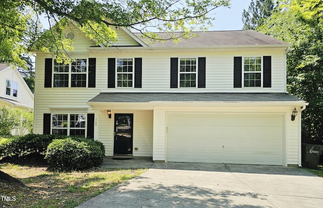 709 Woodgreen Dr, Durham, NC 27704 - view of front of home with an attached garage, driveway, and roof with shingles