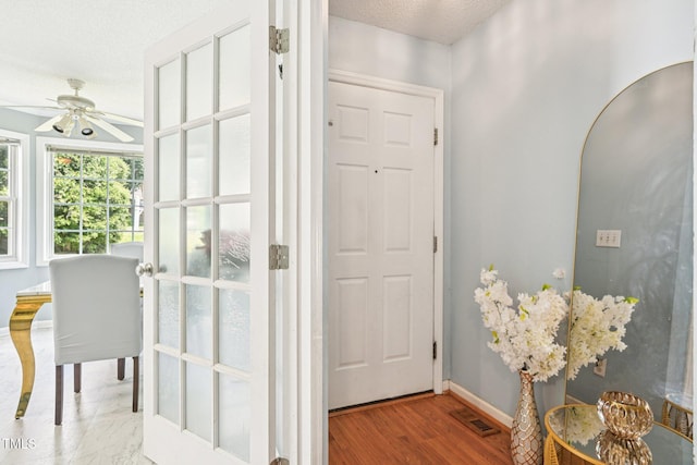 2636 Scattered Oak Ct, Raleigh, NC 27603 - foyer entrance with ceiling fan, a textured ceiling, and wood finished floors