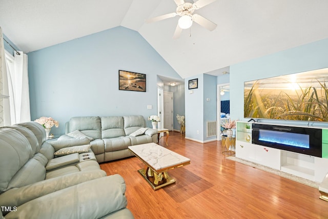 2636 Scattered Oak Ct, Raleigh, NC 27603 - living area with ceiling fan, wood finished floors, a glass covered fireplace, and high vaulted ceiling