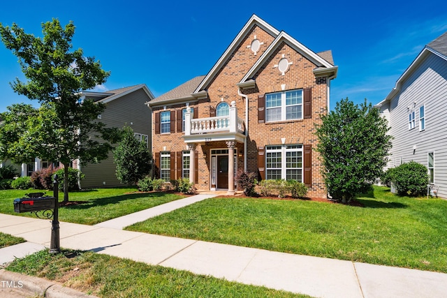2129 Glade Valley Ln, Morrisville, NC 27560 - colonial-style house with brick siding, a front yard, and a balcony