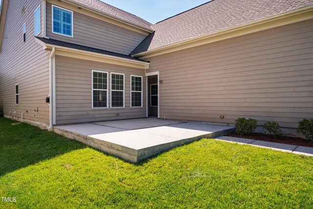 2129 Glade Valley Ln, Morrisville, NC 27560 - back of house with a patio area, a lawn, and a shingled roof