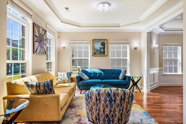 2129 Glade Valley Ln, Morrisville, NC 27560 - living room with a tray ceiling, wood finished floors, crown molding, and a wainscoted wall
