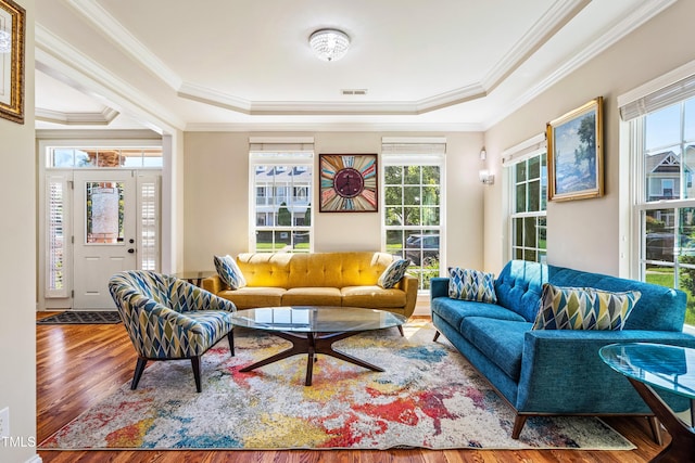 2129 Glade Valley Ln, Morrisville, NC 27560 - living area featuring a tray ceiling, wood finished floors, ornamental molding, and plenty of natural light
