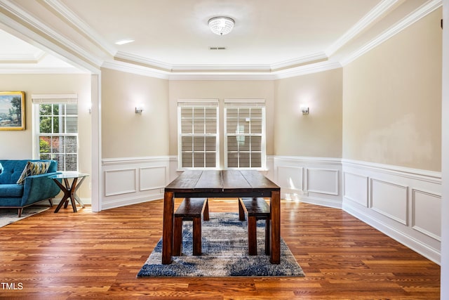 2129 Glade Valley Ln, Morrisville, NC 27560 - dining area featuring wood finished floors, ornamental molding, wainscoting, and a decorative wall