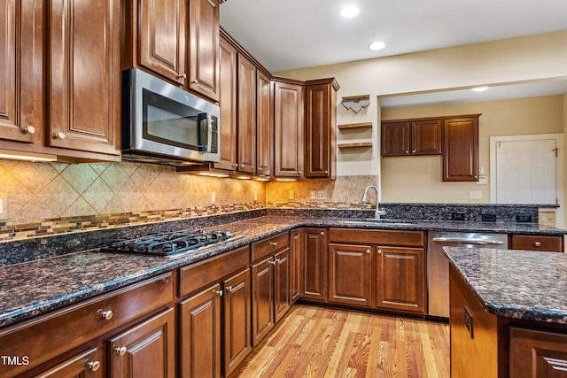 2129 Glade Valley Ln, Morrisville, NC 27560 - kitchen with appliances with stainless steel finishes, open shelves, light wood-style flooring, dark stone countertops, and tasteful backsplash